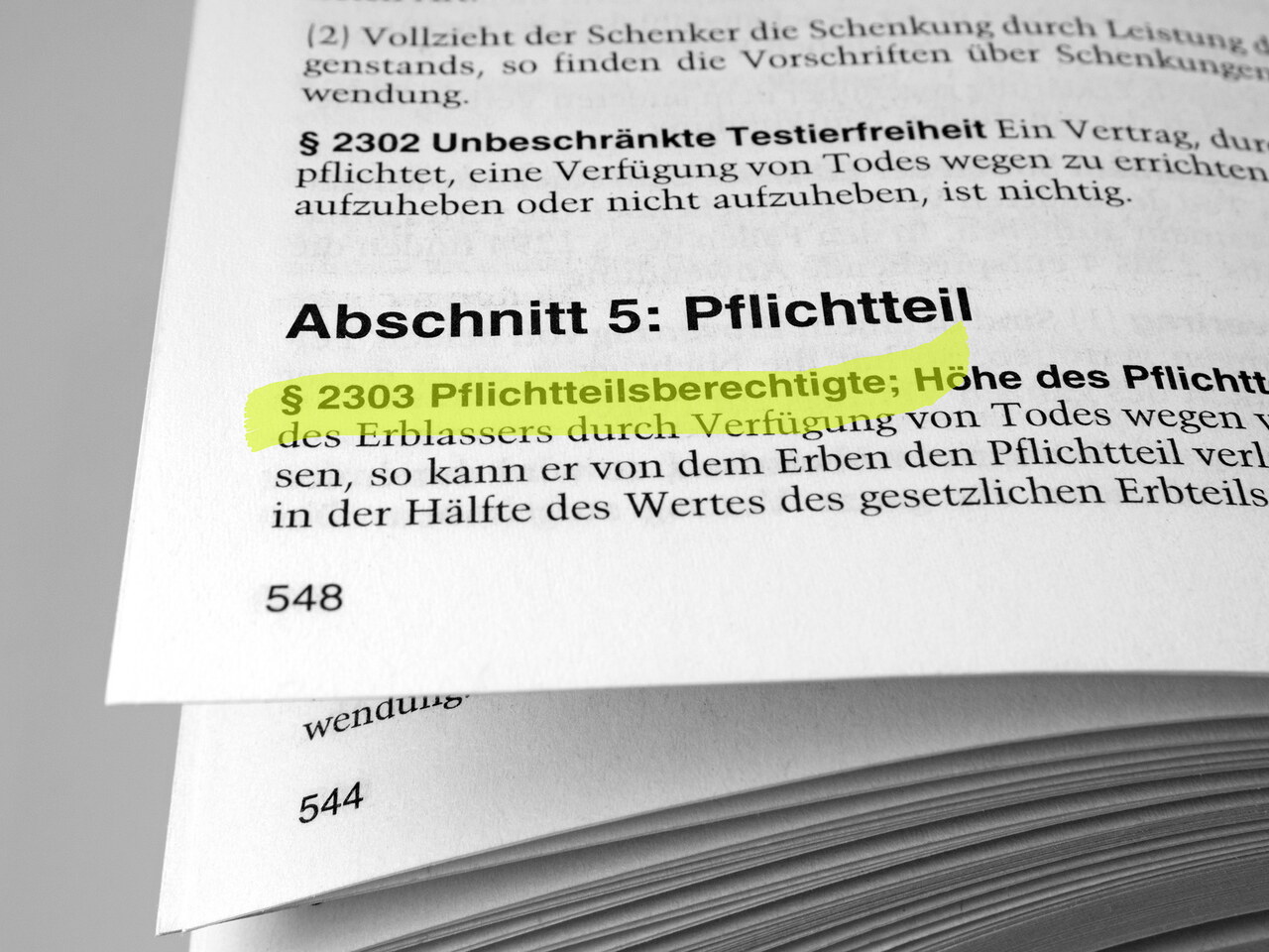 Die aufgeschlagene Seite eines Gesetzestextes zeigt den Abschnitt zum Pflichtteil